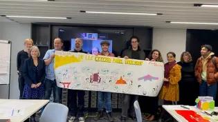 Delegates of the workshop holding up a visual representation of their ideas