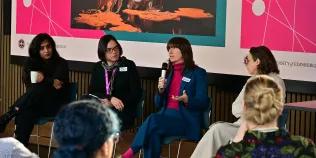 Oliver Plender speaks into a mic while the other panelists listen.