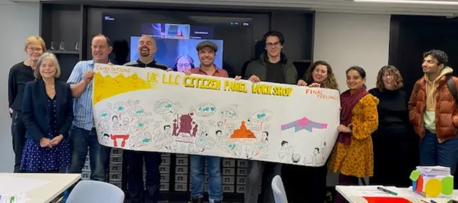 Members of the Citizen Panel Workshop holding up a visual representation of the outcomes and ideas