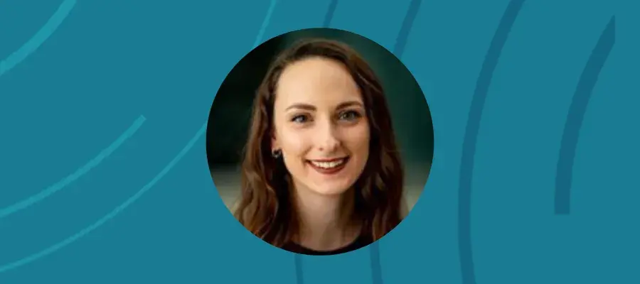 An image of a woman smiling in a circle style frame, on a blue background.