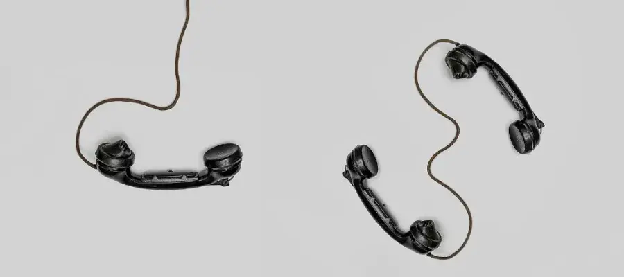 Three black phone handsets on a white background