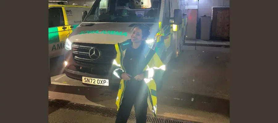 PhD student, Areej Almutairi, standing infront of a Scottish ambulance