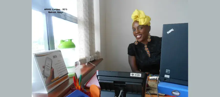 Marylene Wamukoya, PhD student, sitting at her desk in Kenya