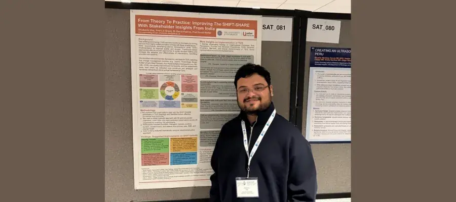 Photograph of Shukanto Das, PhD Student, standing by his poster presentation