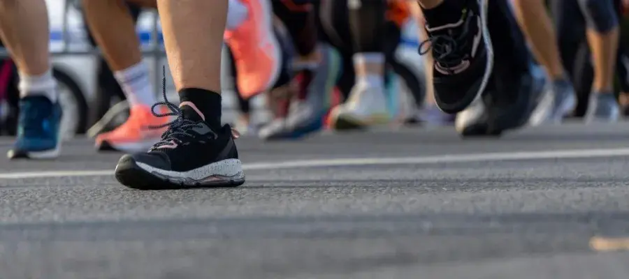 Close-Up of Marathon Runners' Feet in Motion