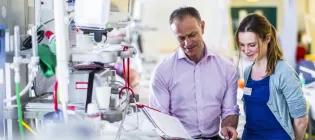 ICU staff discuss patient notes in the ward