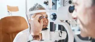 photograph of optician performing an eye test on woman