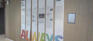 Photograph showing the student exhibition entitled "We have always been here. And we always will be." displayed within the Usher Building