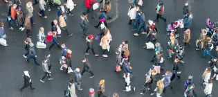 Ariel view of a crowd of pedestrians crossing a street in central Edinburgh