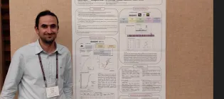 ACRC Student in front of poster