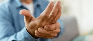 Close up of older man massaging hand