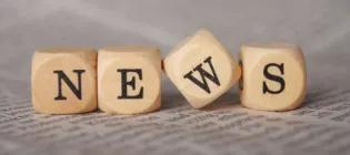 Lettered, wooden blocks laid out to spell "NEWS"