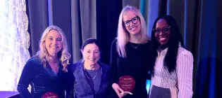 USHER Photograph of Clare MacRae receiving the 2025 NAPCRG New Investigator Award 