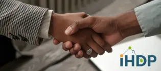 Photograph of a handshake with IHDP logo