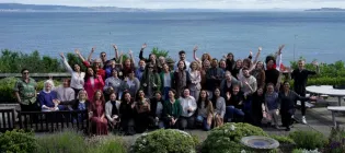 A photograph of the attendees in front of the Firth of Forth
