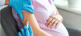 Close up of pregnant woman receiving vaccination