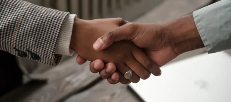 Photograph of a male and female shaking hands