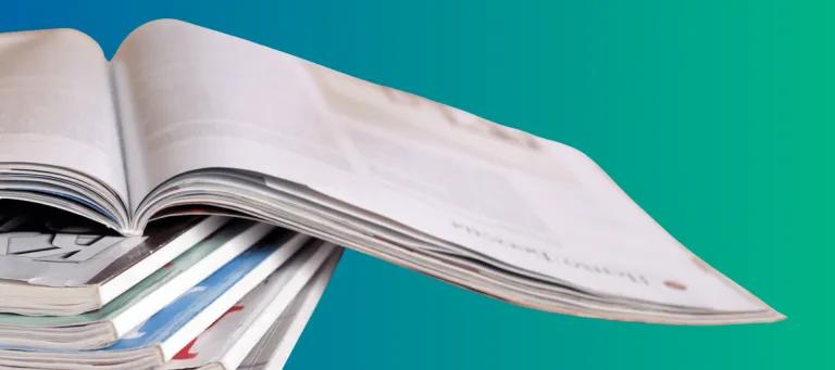 Blue-green background, white newspaper in front