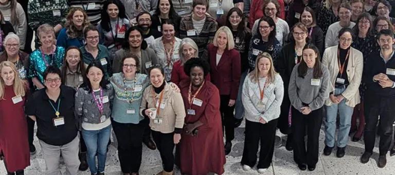 Photo of a group of students, staff and alumni smiling