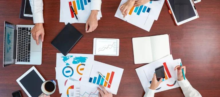 Team working together at one desk 