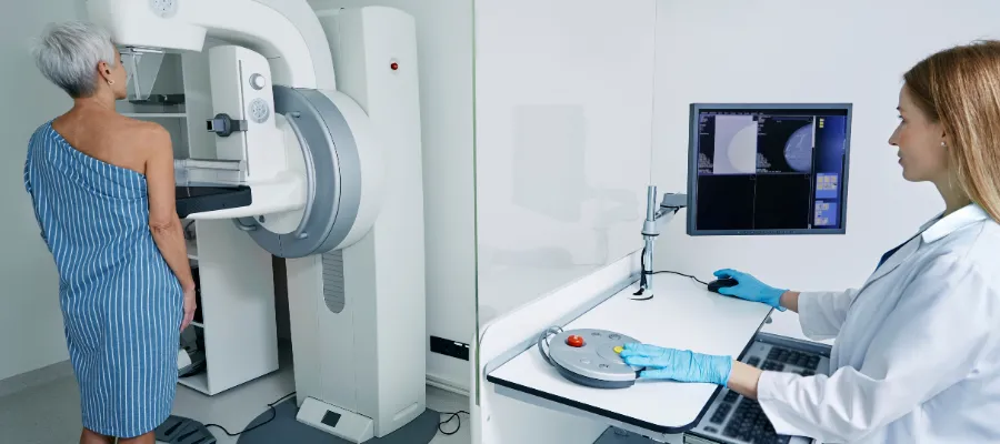 Women undergoing a breast screening service with professional staff member present