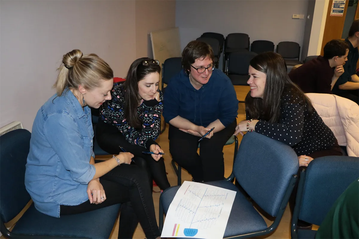 Research nurses discuss in a workshop setting