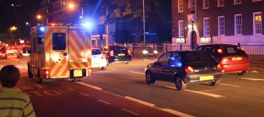 Ambulance travelling through dark streets