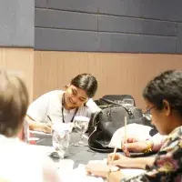 People taking notes at discussion table