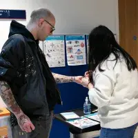 A person holds out their arm for a temporary tattoo.
