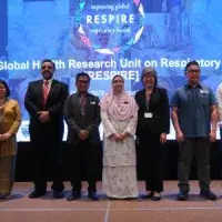 Eight people standing on a stage