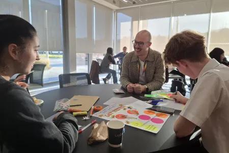 Photograph of Jaime Garcia-Iglesias and high school students at workshop 
