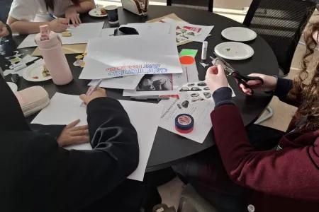 Photograph of high school students creating HIV and Stigma posters in a workshop