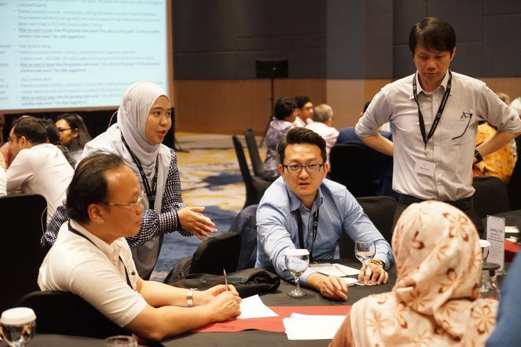 People having a discussion around a table