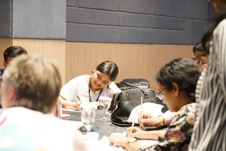 People taking notes at discussion table