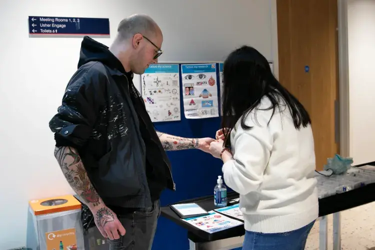 A person holds out their arm for a temporary tattoo.