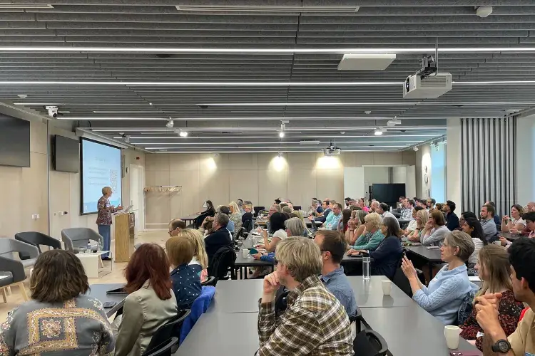 Photograph of audience and presenters during the Usher Connects | Sudlow Review event