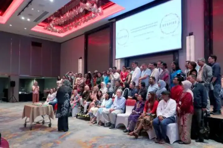 A speech being presented to a group of people stood on a stage