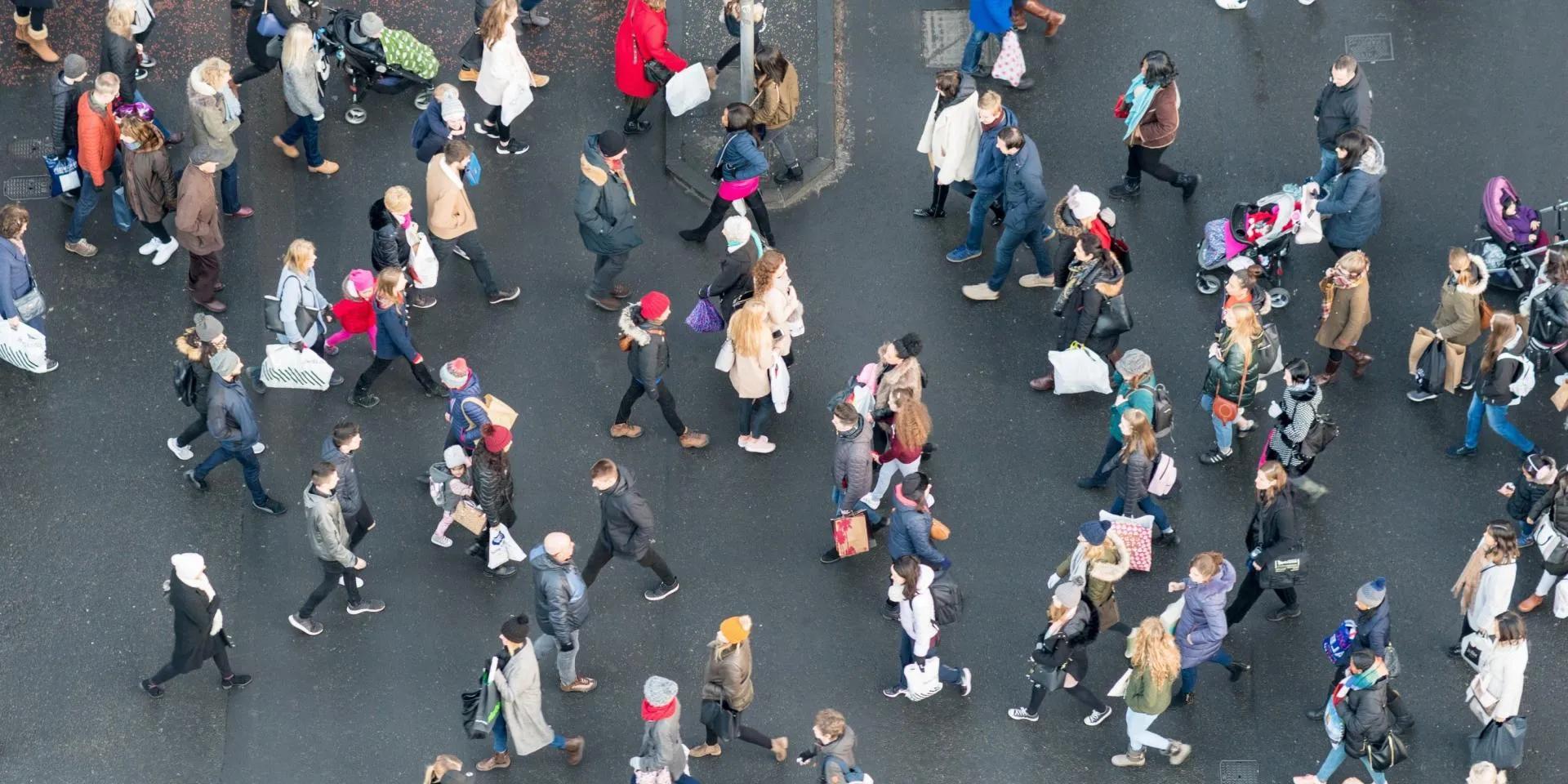 Ariel view of a crowd of pedestrians crossing a street in central Edinburgh