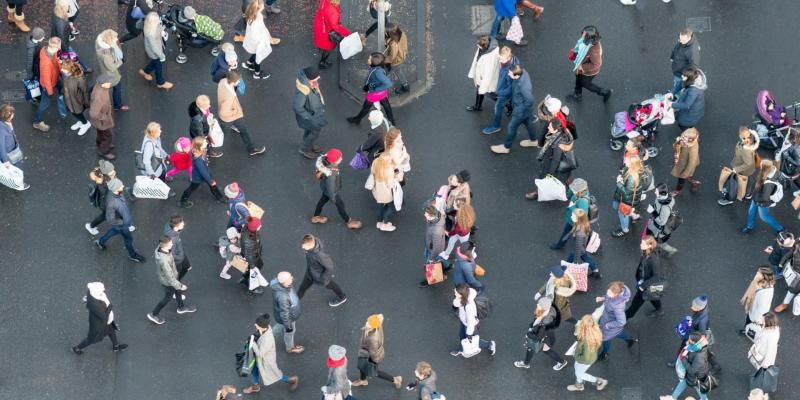Ariel view of a crowd of pedestrians crossing a street in central Edinburgh