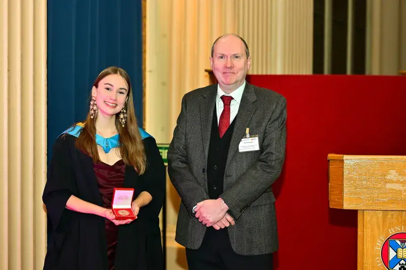 Zoe Nylund being presented with 2025 Brotherston Award by Niall Anderson