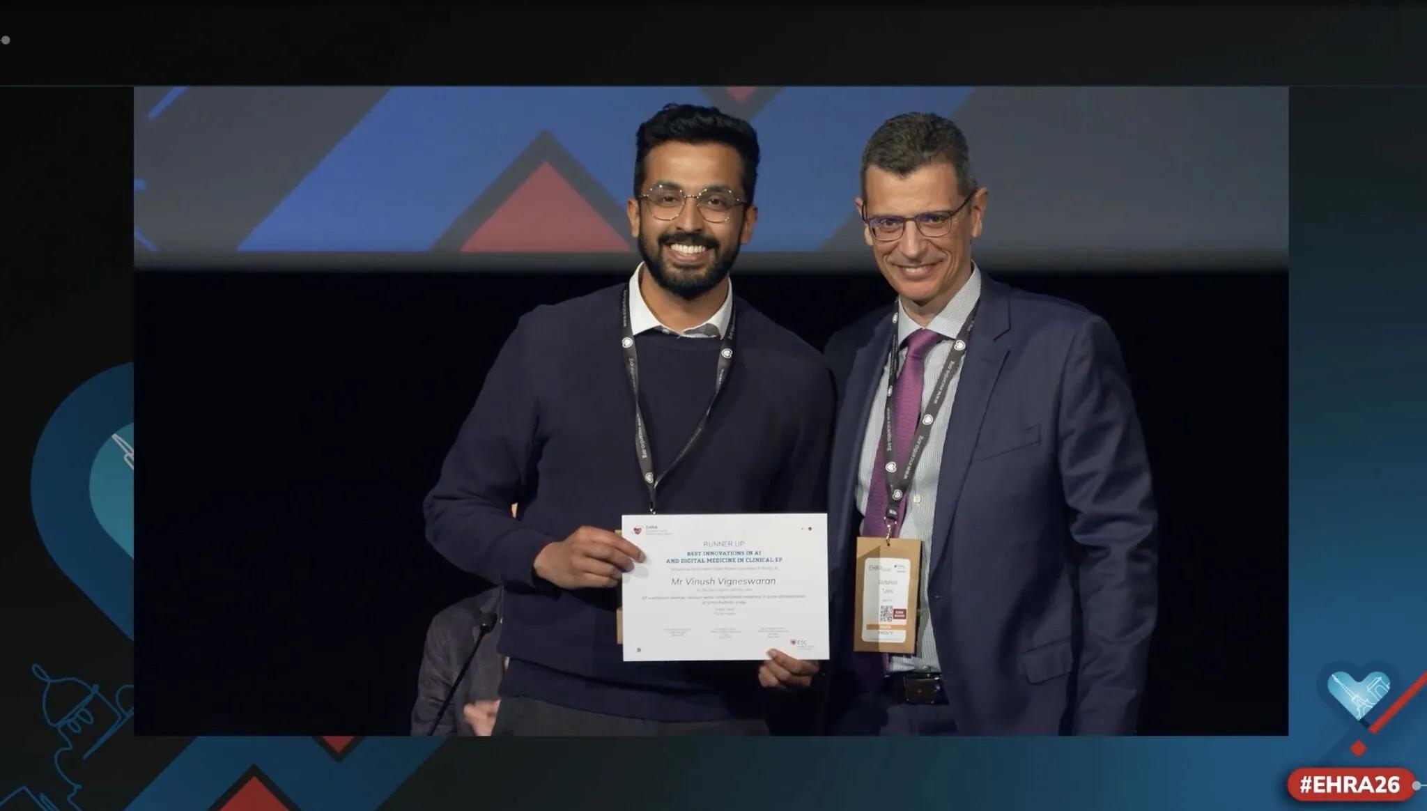 Vinush Vigneswaran presented with Best Innovations in AI and Digital Medicine in Clinical EP award by Stylianos Tzeis, EHRA Scientific Programme Committee Co-Chair