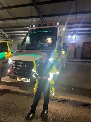 PhD student, Areej Almutairi, standing infront of a Scottish ambulance