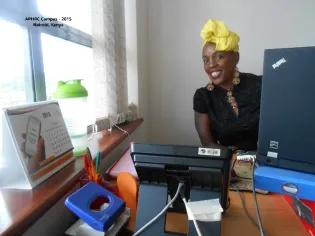 Photograph of PhD student, Marylene Wamukoya, sitting at her desk in Kenya