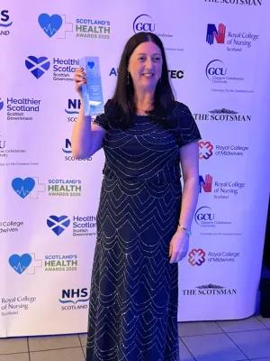 Photograph of Claire Yerramasu holding her Allied Health Professional Award at the 2025 Scotland's Health Awards event