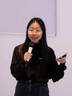 A photograph of Melody presenting her work.