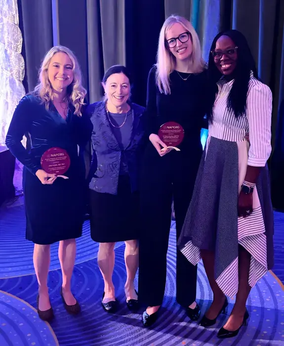 Photograph of Clare MacRae (second from right) accepting the 2025 NAPCRG New Investigator Award