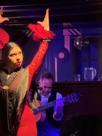 A flamenco dancer performs whilst a guitarist accompanies her