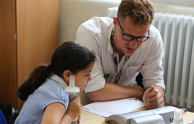 Image of a schoolgirl using a spirometer