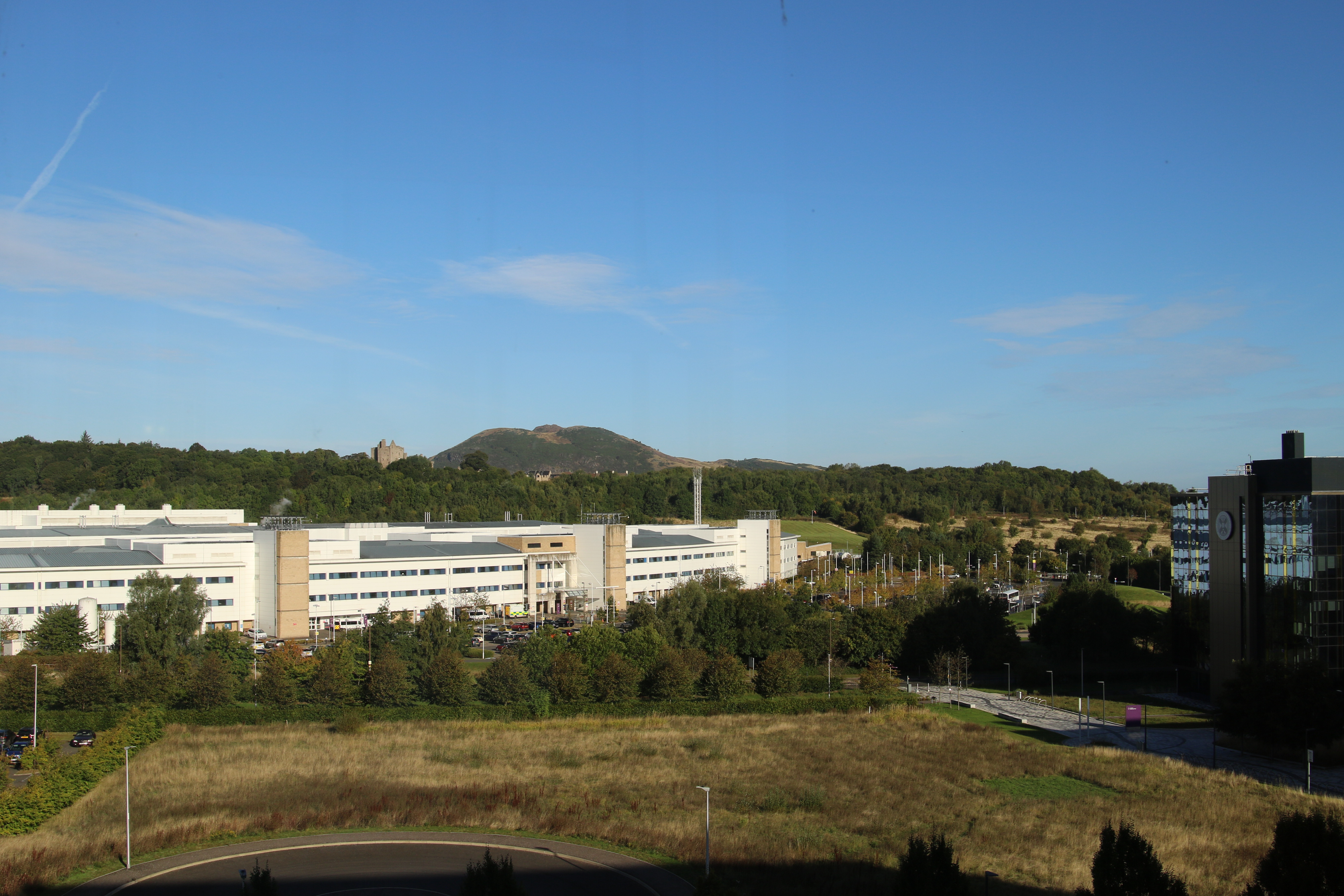 Photograph taken from the Usher Building overlooking Edinburgh Royal Infirmary, Craigmillar Castle and Arthur's Seat