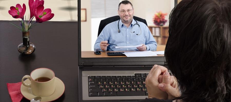 Woman video calling her doctor on a laptop